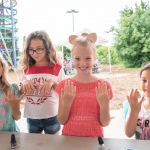 female campers getting their nails painted